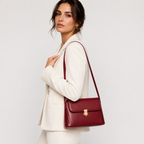 Push-lock shoulder bag worn over the shoulder
