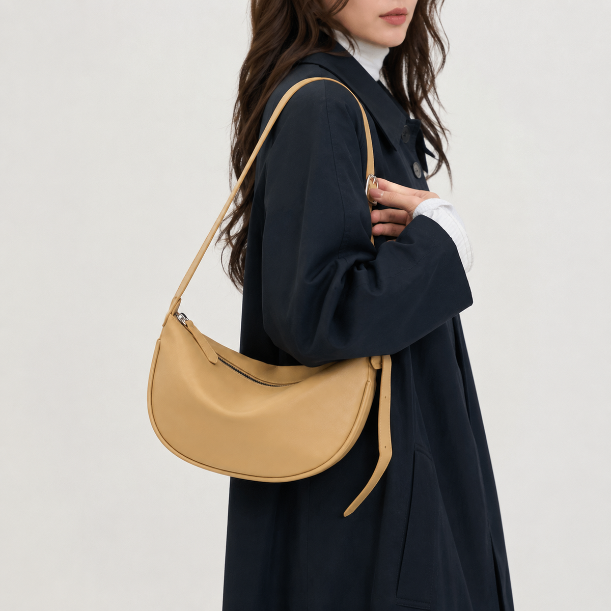 Half-moon crossbody bag shown from the side
